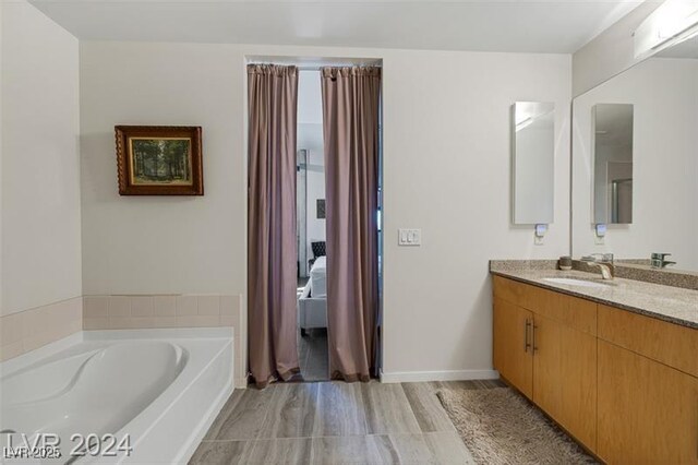 ensuite bathroom with vanity and a garden tub