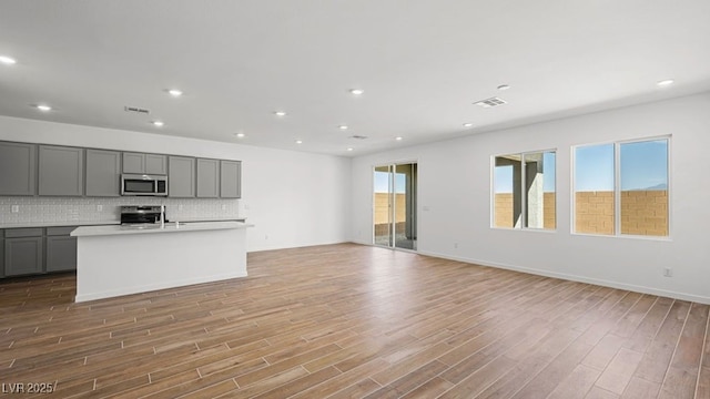 4410 E Brusca Way, Pahrump, NV 89061 - unfurnished living room with light wood-type flooring, recessed lighting, and baseboards