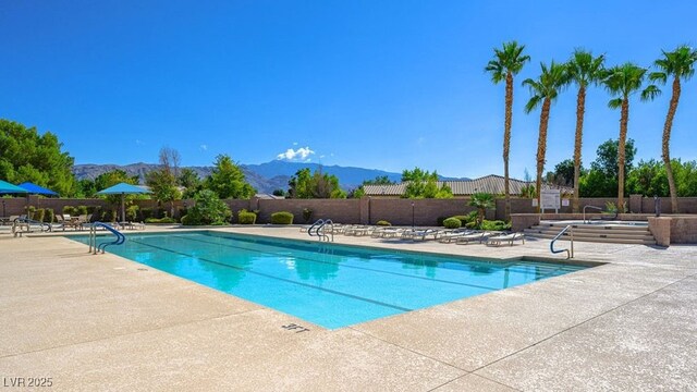 4410 E Brusca Way, Pahrump, NV 89061 - community pool with a patio area, a mountain view, and fence