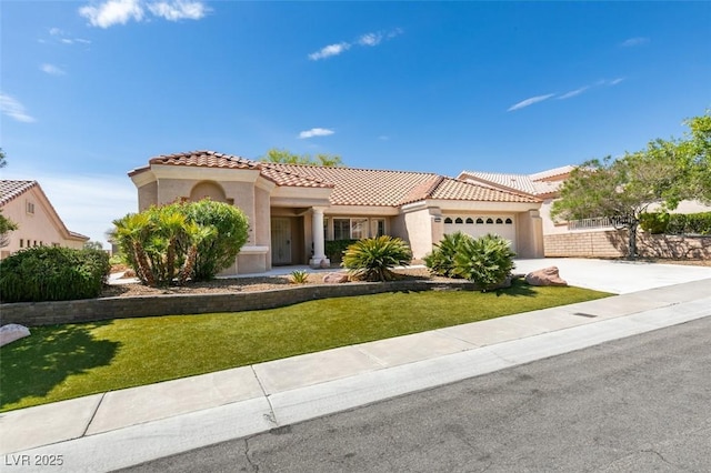 10009 Netherton Dr, Las Vegas, NV 89134 - mediterranean / spanish-style house featuring stucco siding, a tile roof, a garage, and concrete driveway