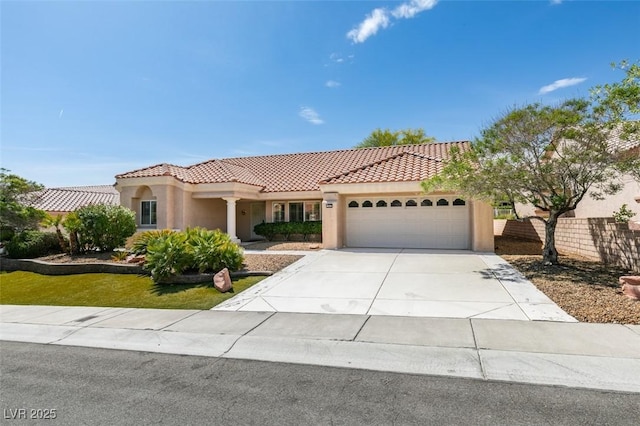 10009 Netherton Dr, Las Vegas, NV 89134 - mediterranean / spanish house featuring a tiled roof, a garage, stucco siding, concrete driveway, and fence