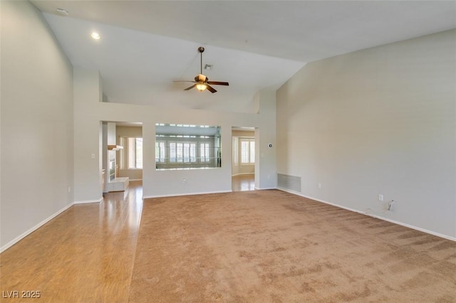 10009 Netherton Dr, Las Vegas, NV 89134 - unfurnished living room featuring ceiling fan, vaulted ceiling, baseboards, and carpet floors