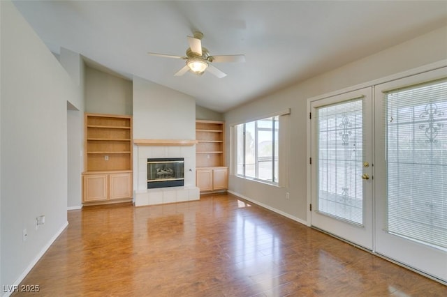 10009 Netherton Dr, Las Vegas, NV 89134 - unfurnished living room with vaulted ceiling, french doors, baseboards, a ceiling fan, and built in shelves