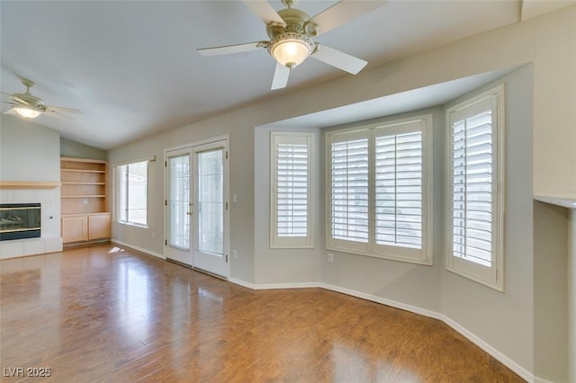 10009 Netherton Dr, Las Vegas, NV 89134 - unfurnished living room featuring ceiling fan, wood finished floors, baseboards, and lofted ceiling