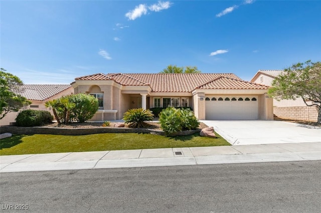 10009 Netherton Dr, Las Vegas, NV 89134 - mediterranean / spanish house with an attached garage, stucco siding, and a tile roof