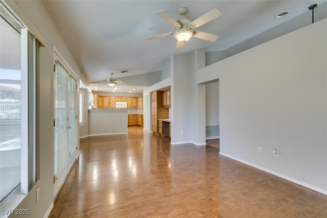 10009 Netherton Dr, Las Vegas, NV 89134 - unfurnished living room featuring ceiling fan, vaulted ceiling, baseboards, and wood finished floors