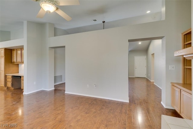 10009 Netherton Dr, Las Vegas, NV 89134 - unfurnished living room with a ceiling fan, dark wood finished floors, baseboards, lofted ceiling, and recessed lighting