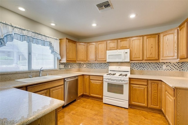 10009 Netherton Dr, Las Vegas, NV 89134 - kitchen with white appliances, a sink, decorative backsplash, light countertops, and recessed lighting