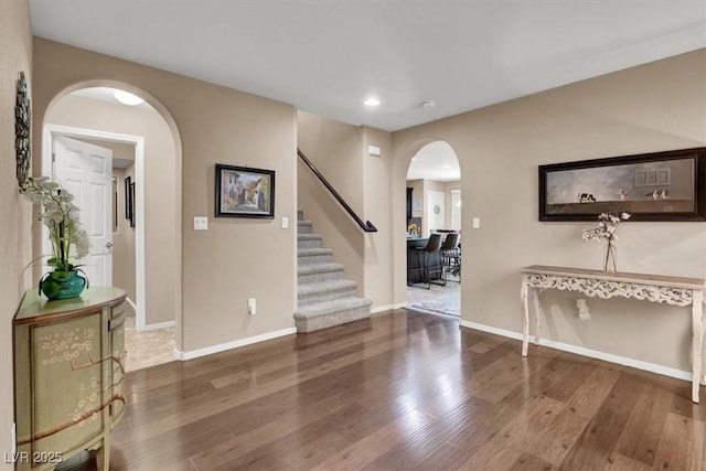 10230 Danskin Dr, Las Vegas, NV 89166 - entrance foyer with arched walkways, wood finished floors, stairs, recessed lighting, and baseboards