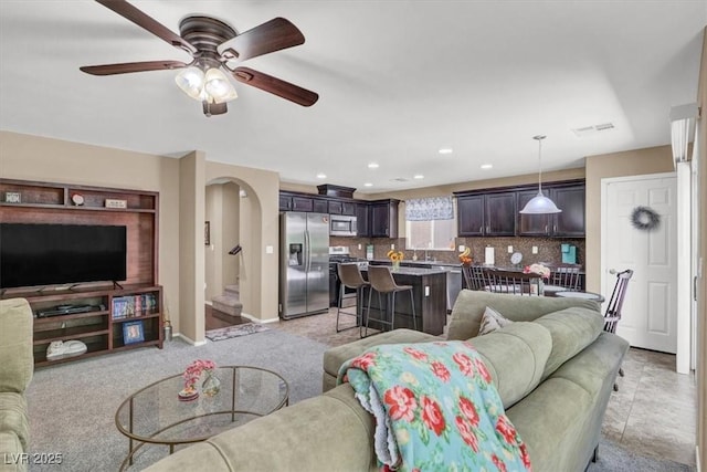 10230 Danskin Dr, Las Vegas, NV 89166 - living room featuring arched walkways, a ceiling fan, recessed lighting, and baseboards