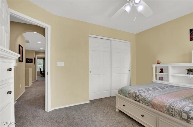 10230 Danskin Dr, Las Vegas, NV 89166 - carpeted bedroom with arched walkways, a closet, a ceiling fan, and baseboards
