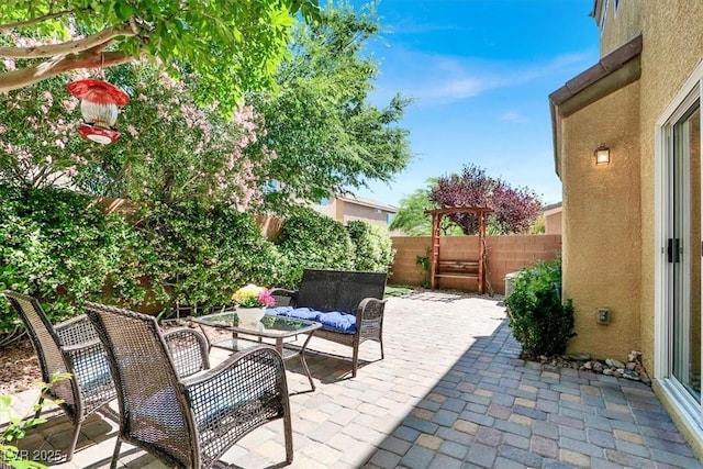 10230 Danskin Dr, Las Vegas, NV 89166 - fenced backyard with a patio and an outdoor hangout area