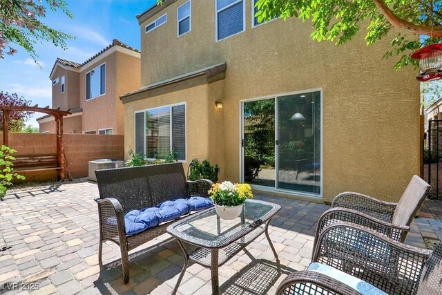 10230 Danskin Dr, Las Vegas, NV 89166 - rear view of house with stucco siding, a patio area, an outdoor living space, and central AC unit