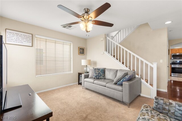 6488 Bentley Wood Ct, Las Vegas, NV 89130 - carpeted living area featuring ceiling fan, stairway, and baseboards