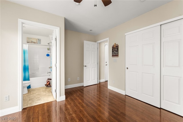 6488 Bentley Wood Ct, Las Vegas, NV 89130 - unfurnished bedroom with wood finished floors, a closet, baseboards, and ensuite bath