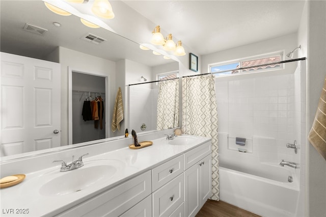 6488 Bentley Wood Ct, Las Vegas, NV 89130 - full bathroom with double vanity, shower / bath combo with shower curtain, and wood finished floors