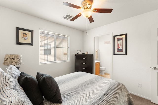 6488 Bentley Wood Ct, Las Vegas, NV 89130 - bedroom featuring light colored carpet, baseboards, connected bathroom, and ceiling fan