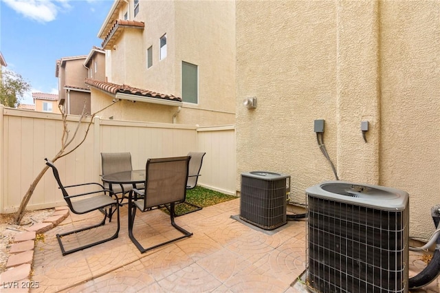 6488 Bentley Wood Ct, Las Vegas, NV 89130 - view of patio featuring central AC unit, fence, and outdoor dining space