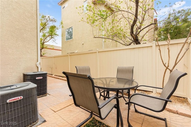 6488 Bentley Wood Ct, Las Vegas, NV 89130 - view of patio with outdoor dining space, central AC unit, and fence