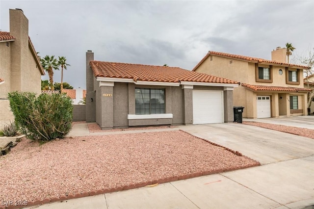 1744 La Cruz Dr, Henderson, NV 89014 - mediterranean / spanish home with concrete driveway, stucco siding, an attached garage, a chimney, and a tile roof