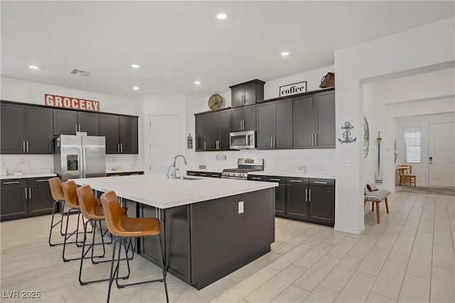 709 Corelli Cove St, Henderson, NV 89011 - kitchen with appliances with stainless steel finishes, a sink, an island with sink, light countertops, and recessed lighting