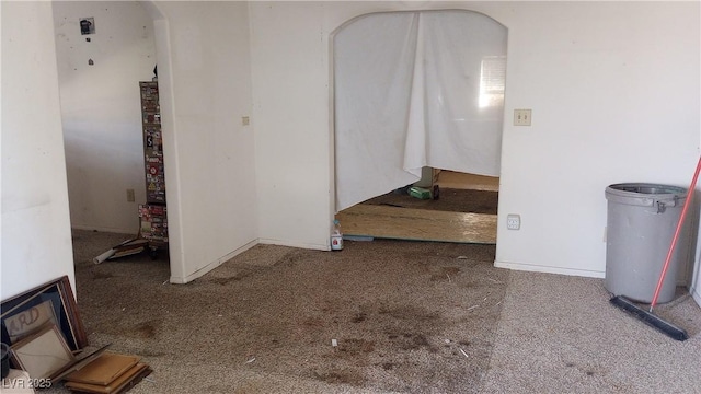 336 Hoffman St, Pioche, NV 89043 - empty room featuring carpet flooring, arched walkways, and baseboards