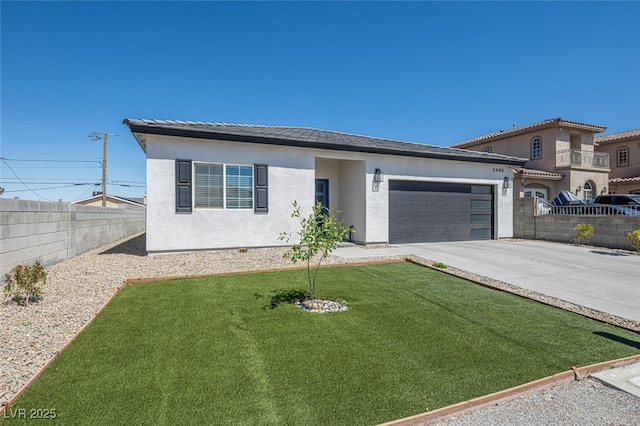 view of front of property featuring stucco siding, driveway, an attached garage, and a tiled roof