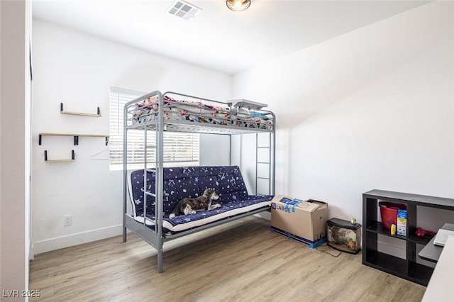 bedroom with wood finished floors and baseboards