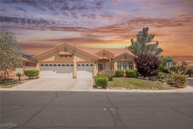 3882 Genoa Dr, Las Vegas, NV 89141 - mediterranean / spanish-style home with a garage, driveway, a tile roof, and stucco siding