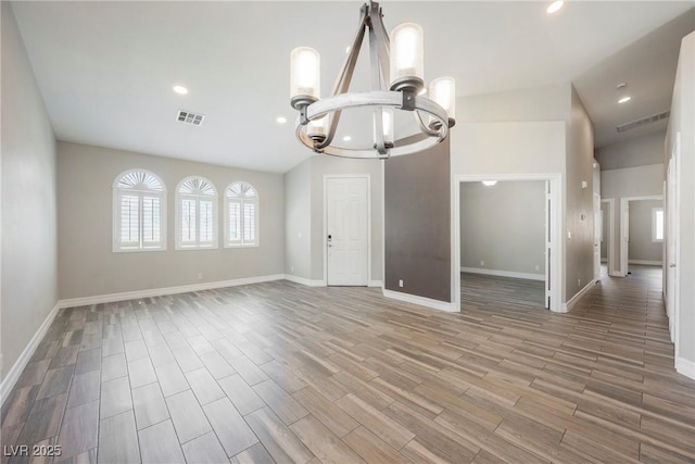 3882 Genoa Dr, Las Vegas, NV 89141 - unfurnished living room featuring a chandelier, recessed lighting, wood finished floors, baseboards, and vaulted ceiling