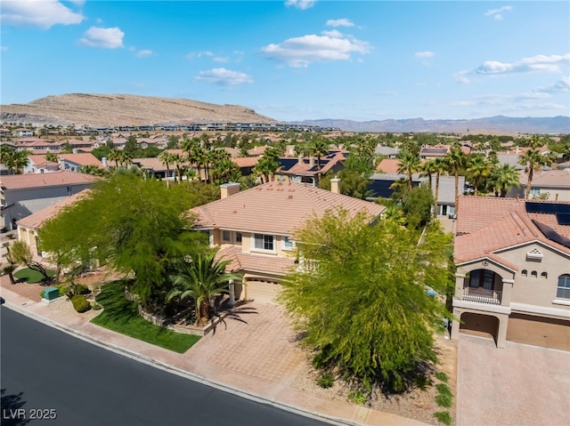 aerial view of residential area featuring a mountain backdrop