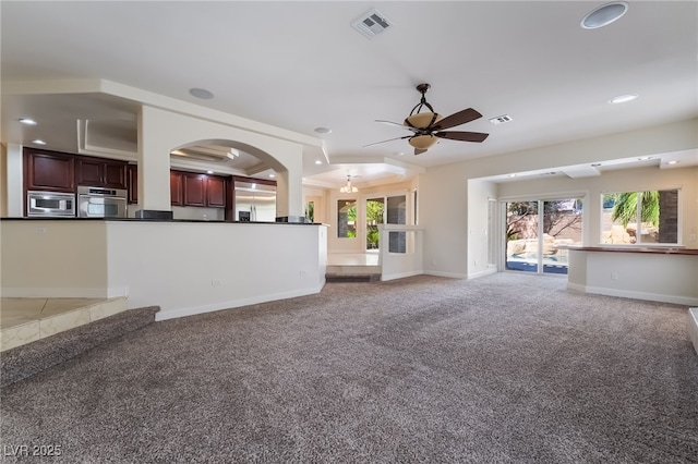 unfurnished living room featuring light colored carpet, ceiling fan, healthy amount of natural light, baseboards, and recessed lighting