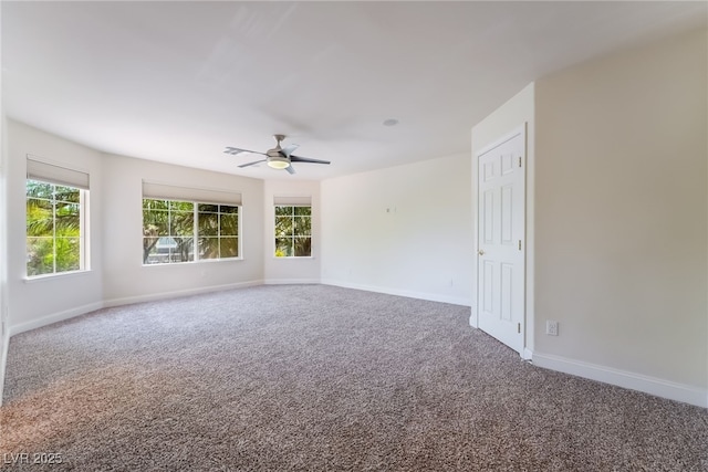 spare room with carpet flooring, a ceiling fan, and baseboards