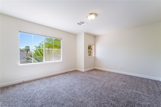 carpeted empty room with baseboards