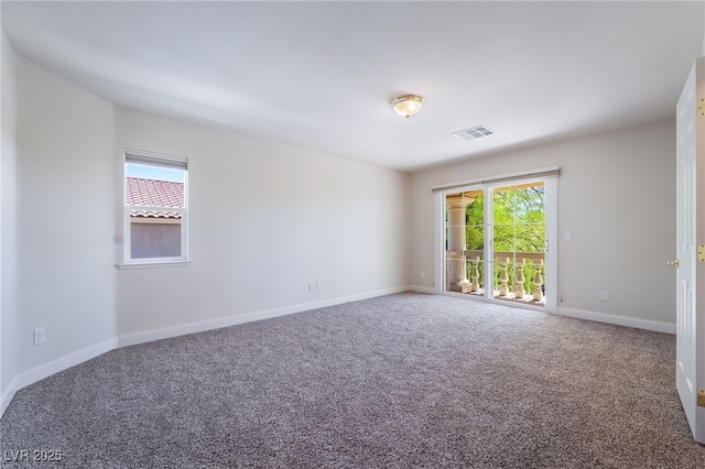carpeted spare room with baseboards
