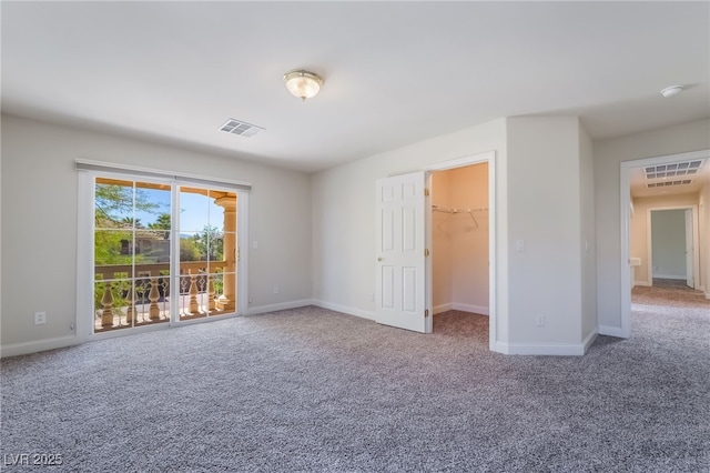 carpeted spare room featuring baseboards
