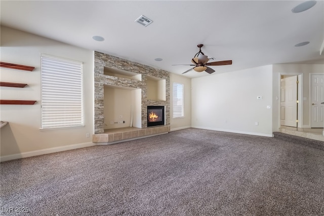 unfurnished living room featuring ceiling fan, carpet, baseboards, and a tile fireplace