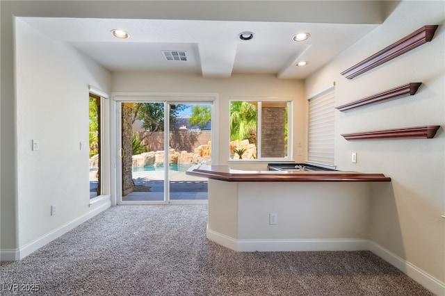 kitchen with carpet flooring, recessed lighting, and baseboards