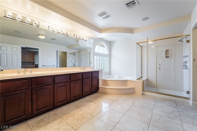 full bathroom featuring a stall shower, a bath, double vanity, and marble finish flooring