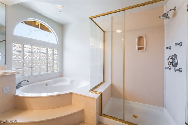 full bath featuring a stall shower and a bath