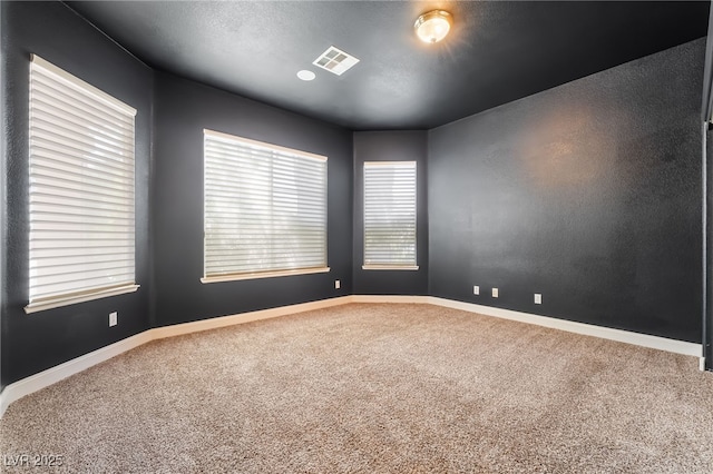 unfurnished room with carpet floors and baseboards