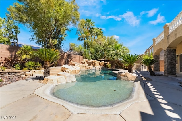 view of pool with a fenced backyard and a patio