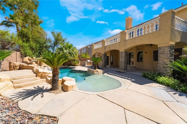 view of pool with a patio and ceiling fan