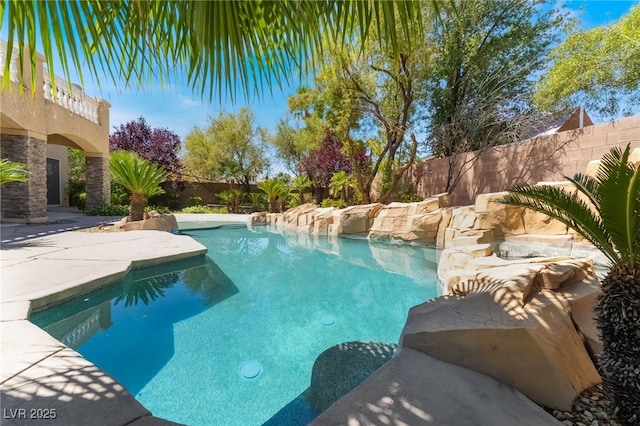 view of swimming pool with a fenced backyard and a patio