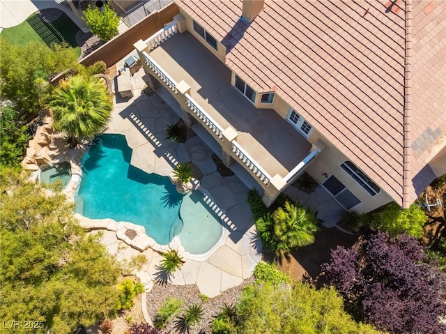 aerial view of property and surrounding area with a pool area