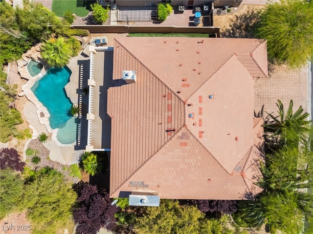 aerial view of property and surrounding area featuring a pool area