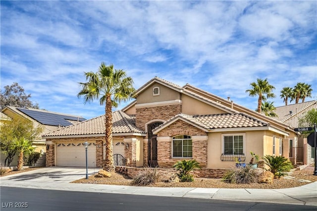 1532 Via Cassia, Henderson, NV 89052 - view of front of home with stone siding, stucco siding, a garage, concrete driveway, and a tile roof