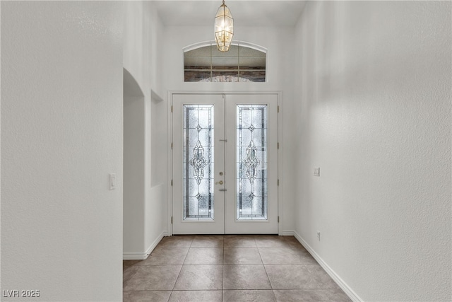 1532 Via Cassia, Henderson, NV 89052 - foyer entrance with french doors, baseboards, light tile patterned floors, and arched walkways