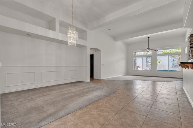 1532 Via Cassia, Henderson, NV 89052 - unfurnished room featuring a chandelier, arched walkways, tile patterned flooring, beam ceiling, and baseboards