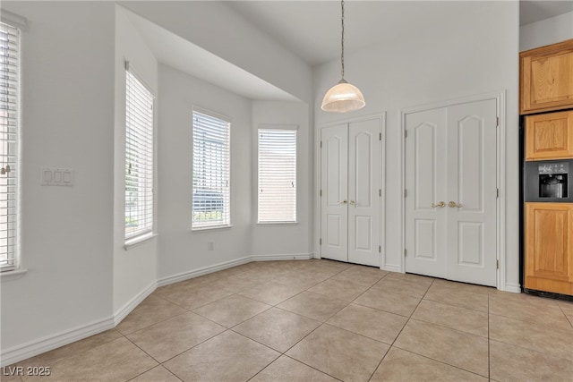 1532 Via Cassia, Henderson, NV 89052 - unfurnished dining area with light tile patterned floors and baseboards